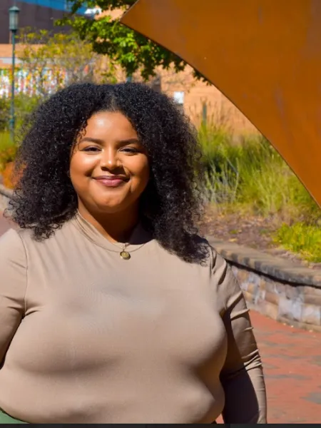 Person wearing brown shirt smiling 