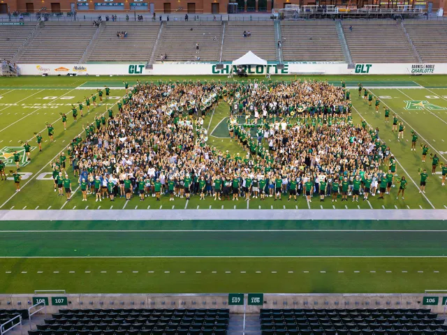Incoming Class of 2025 group photo on football field in shape of C logo